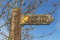 Traditional country wooden public footpath sign to cenotaph monument, with trees in background, Wereth Low, Greater Manchester Royalty Free Stock Photo