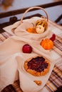 traditional cozy setting of autumn table for picnic with fruits and homemade pie