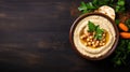 Traditional Creamy Hummus Served With Pita Bread and Vegetables on a Dark Wooden Table