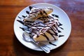 Traditional crepes with banana and chocolate cream Royalty Free Stock Photo