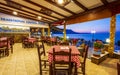 Traditional Cretan Food Restaurant at Paraliaki promenaad at sunset in Kissamos, Crete, Greek Islands, Greece, Europe Royalty Free Stock Photo