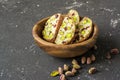 Traditional crispy Italian biscotti or cantuchini crackers with pistachios and dried cranberries in a bowl of olve wood