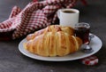 Traditional croissants with jam for breakfast