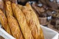 Traditional crusty French bread baguette in basket at bakery. Fresh organic pastry at local market. France cuisine background