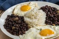 Traditional Cuban cuisine, black beans, rice and fried eggs Royalty Free Stock Photo