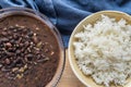 Traditional Cuban cuisine, black beans and rice in two clay bowls Royalty Free Stock Photo