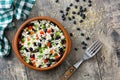 Traditional cuban rice, black beans and pepper on wooden table background. Moros y cristianos.