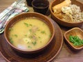 Traditional rustic cuisine of Belarus, russian cuisine: fresh soup and buckwheat in clay dishes on wooden table