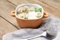 Traditional cuisine. Ravioli, pelmeni with sour cream on wooden table.