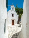 Whitewashed Greek Orthodox Christian Church at Mykonos island Cyclades destination Greece. Vertical Royalty Free Stock Photo