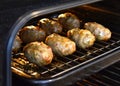 Traditional Cypriot food. Sheftalia : Cypriot Lamb and Pork Sausages on a metal grill being cooking in the oven. Royalty Free Stock Photo