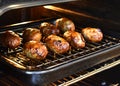 Traditional Cypriot food. Sheftalia : Cypriot Lamb and Pork Sausages on a metal grill being cooking in the oven. Royalty Free Stock Photo