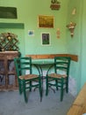 Traditional Cypriot Greek corner with wooden chairs and metal small table Royalty Free Stock Photo