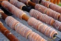 Traditional Czech food `Trdelnik`. A popular dish among tourists to prepared on a wooden skewers over hot coals Royalty Free Stock Photo