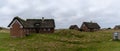 Traditional Danish houses with thatched reed roof in a coastal sand dune landscape Royalty Free Stock Photo