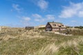 Traditional Danish houses with thatched reed roof in a coastal sand dune landscape Royalty Free Stock Photo