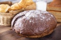 Traditional dark homemade bread with other types of bakery products, top view on a dark wooden table