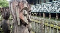 Traditional Dayaknese wood sculpture totem in front of traditional house of Dayak tribe in Pulau Kumala, Indonesia Royalty Free Stock Photo