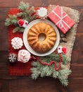 Traditional decorated christmas cake at wooden table