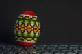 Traditional decorated Eastern egg over computer keyboard isolated on black Royalty Free Stock Photo