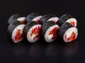 Traditional delicious fresh tobiko sake sushi roll set on a black background with reflection Royalty Free Stock Photo