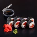 Traditional delicious fresh tobiko sake sushi roll set on a black background with reflection Royalty Free Stock Photo