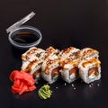 Traditional delicious fresh Unagi Syake sushi roll set on a black background with reflection