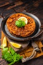 Traditional delicious Turkish foods lahmacun with mince lamb meat in steel tray. Wooden background. Top view Royalty Free Stock Photo