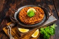 Traditional delicious Turkish foods lahmacun with mince lamb meat in steel tray. Wooden background. Top view Royalty Free Stock Photo