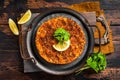 Traditional delicious Turkish foods lahmacun with mince lamb meat in steel tray. Wooden background. Top view Royalty Free Stock Photo