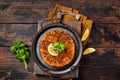Traditional delicious Turkish foods lahmacun with mince lamb meat in steel tray. Wooden background. Top view Royalty Free Stock Photo