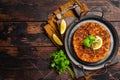 Traditional delicious Turkish foods lahmacun with mince lamb meat in steel tray. Wooden background. Top view. Copy space Royalty Free Stock Photo