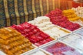 Traditional delights sweet rolls, oriental sweets lukum, lokum, nougat arranged in boxes on the counter of the store Royalty Free Stock Photo