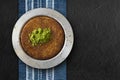 Traditional dessert kunefe with pistachio over black textured background