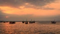 Traditional dhow boats at sunset