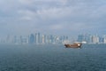 A traditional dhow in Doha, Qatar with the city`s modern skyline in the background. Royalty Free Stock Photo