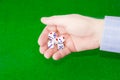 Traditional dice in male hand over table with green cloth Royalty Free Stock Photo