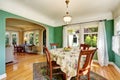 Traditional dining area with wooden table set. Open floor plan. Royalty Free Stock Photo