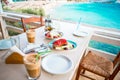 Traditional dinner with delicious fresh greek salad, frappe and brusketa served for lunch at outdoor restaurant with Royalty Free Stock Photo