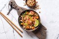 Traditional dish of asian cuisine is pad thai. Udon noodles with shrimps and fried tofu Royalty Free Stock Photo