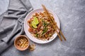 Traditional dish of asian cuisine is pad thai. Udon noodles with shrimps and fried tofu Royalty Free Stock Photo