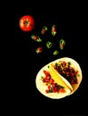 Traditional dish of Mexican cuisine. Corn tortilla tacos with vegetable filling on black background.