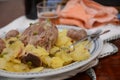 Traditional dish pork shank with potatoes oinon peans in baken on table in restaurant lunch food Royalty Free Stock Photo