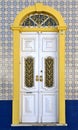 Traditional door in Portugal on a blue tiled facade with yellow typical frame Royalty Free Stock Photo