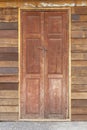 Traditional double wooden door on the Old plank wood vintage style wall for background and texture