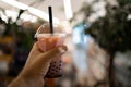 Traditional drink of Taiwan concept. Woman hand holding milk bubble tea with tapioca pearls Royalty Free Stock Photo