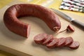 Traditional Dutch horsemeat sausage and slices on a cuttingboard close up Royalty Free Stock Photo