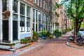 Traditional dutch houses, bicycles parked on city street at summer. Typical holland architecture. Exterior. Amsterdam, Netherlands