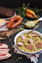 Traditional Dutch pea soup and ingredients on a rustic table Royalty Free Stock Photo