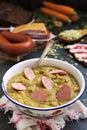 Traditional Dutch pea soup and ingredients on a rustic table Royalty Free Stock Photo